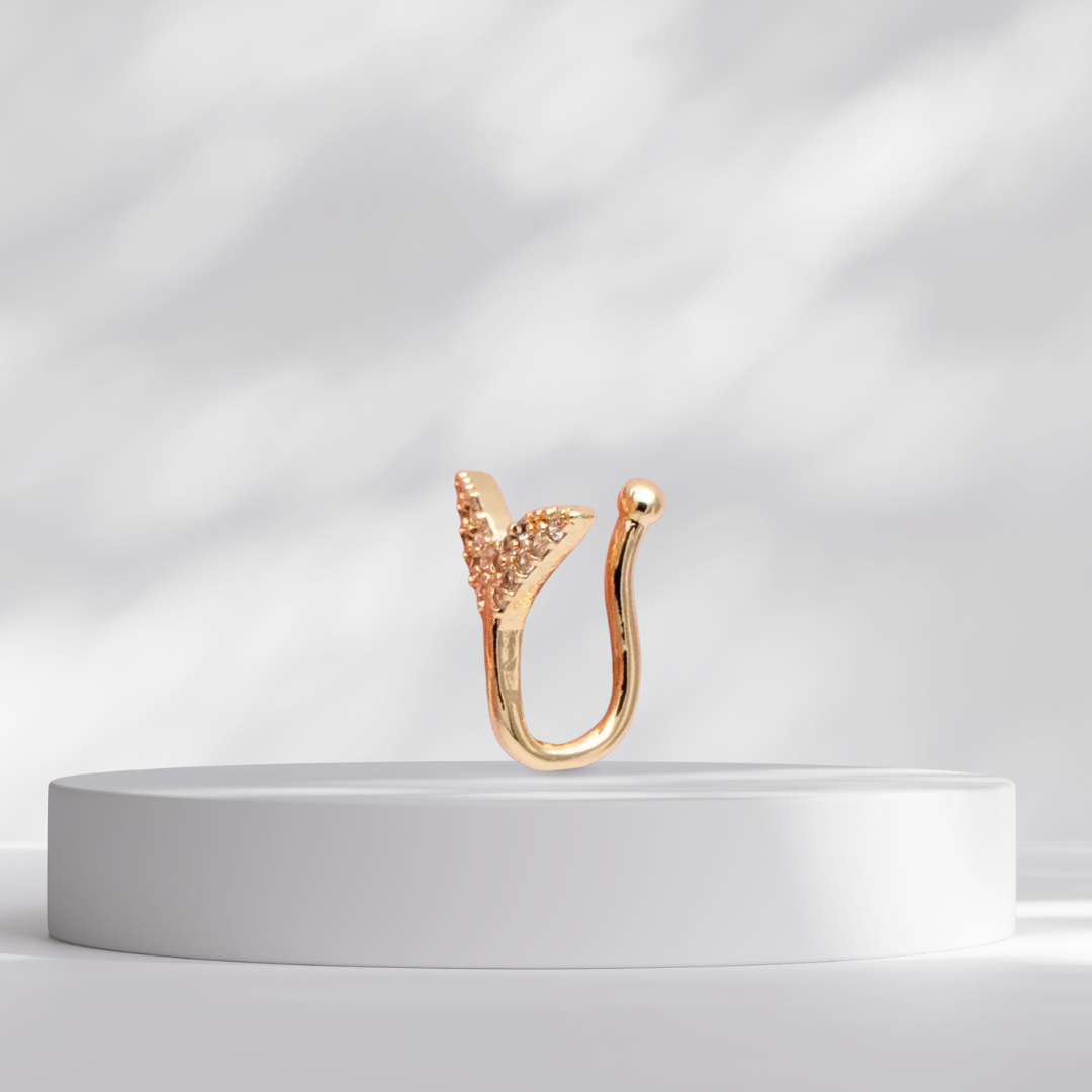 Mermaid Tail Clip on Gold Nose Cuff MaeMae Jewelry on a white pedestal against a light gray background