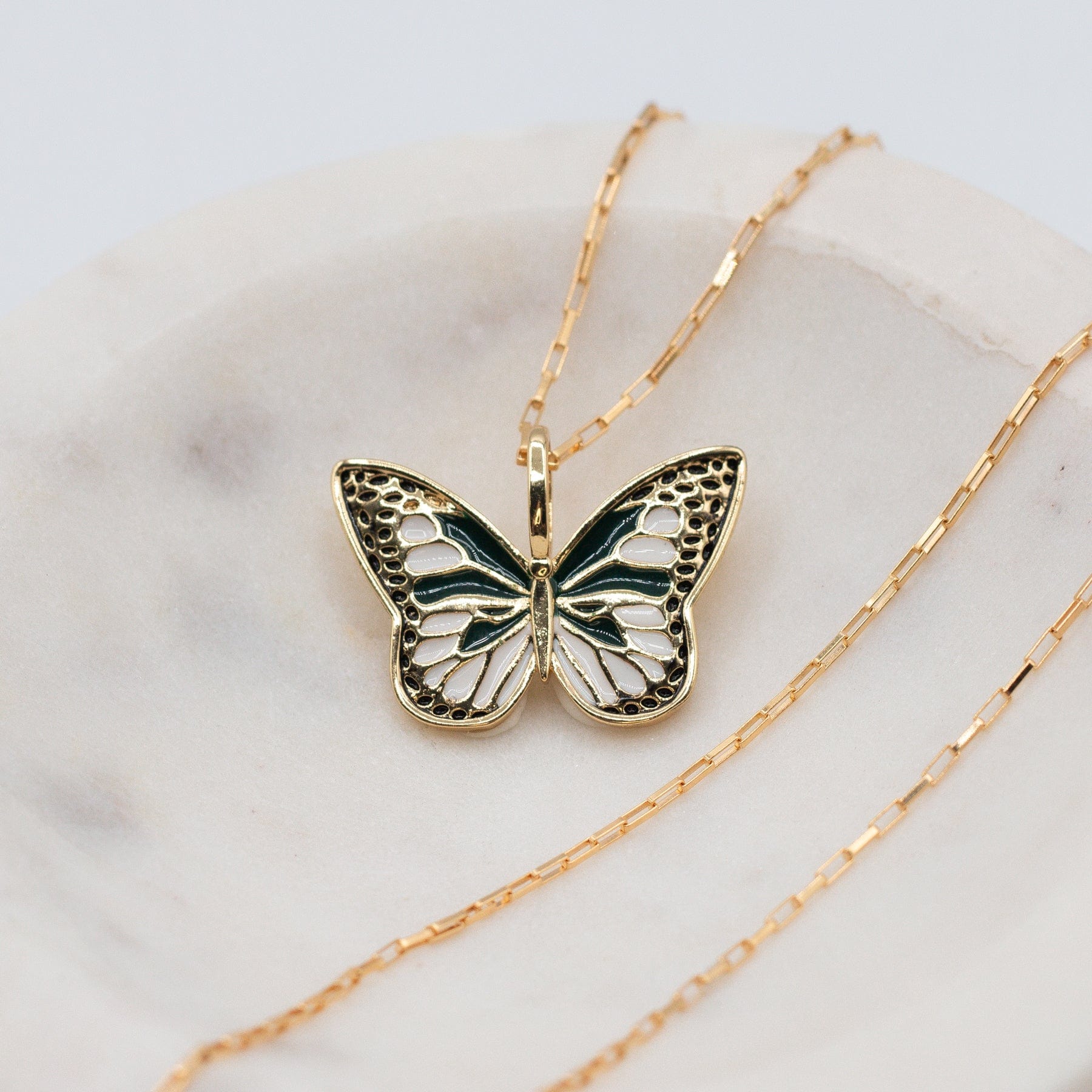 Flutter Butterfly Necklace - Dainty enamel and gold filled green white and gold butterfly charm on mini elongated Venetian chain in marble bowl