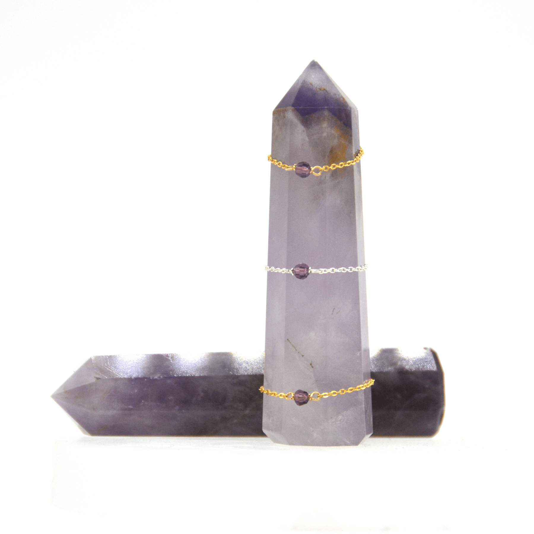 February amethyst rings stacked on an amethyst crystal tower (top to bottom: size 6, size 8, size 10)