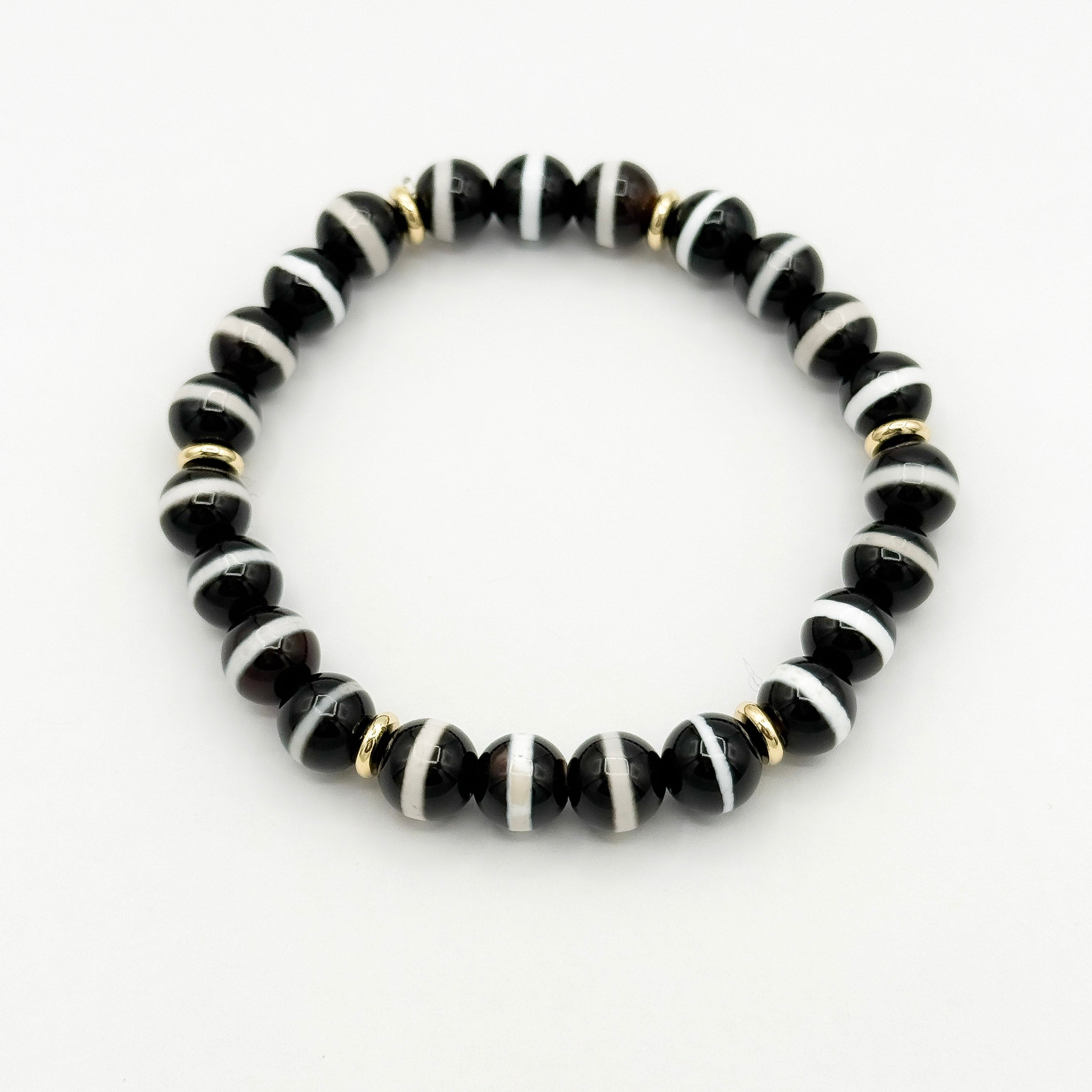 Black Banded Tibetan Agate is known for strong protective energy, grounding, and strengthening your inner resolve.
