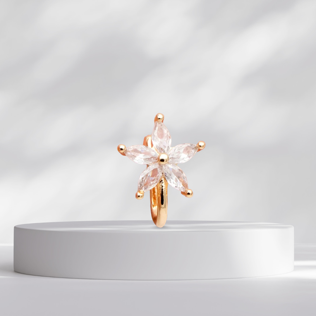 Gold star flower nose cuff on a white platform