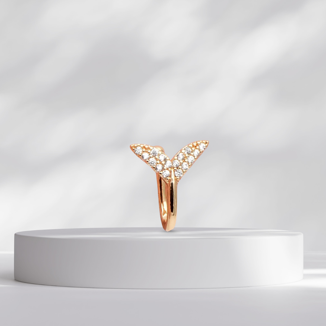 Mermaid Tail Clip on Gold Nose Cuff MaeMae Jewelry on a white pedestal against a light gray background