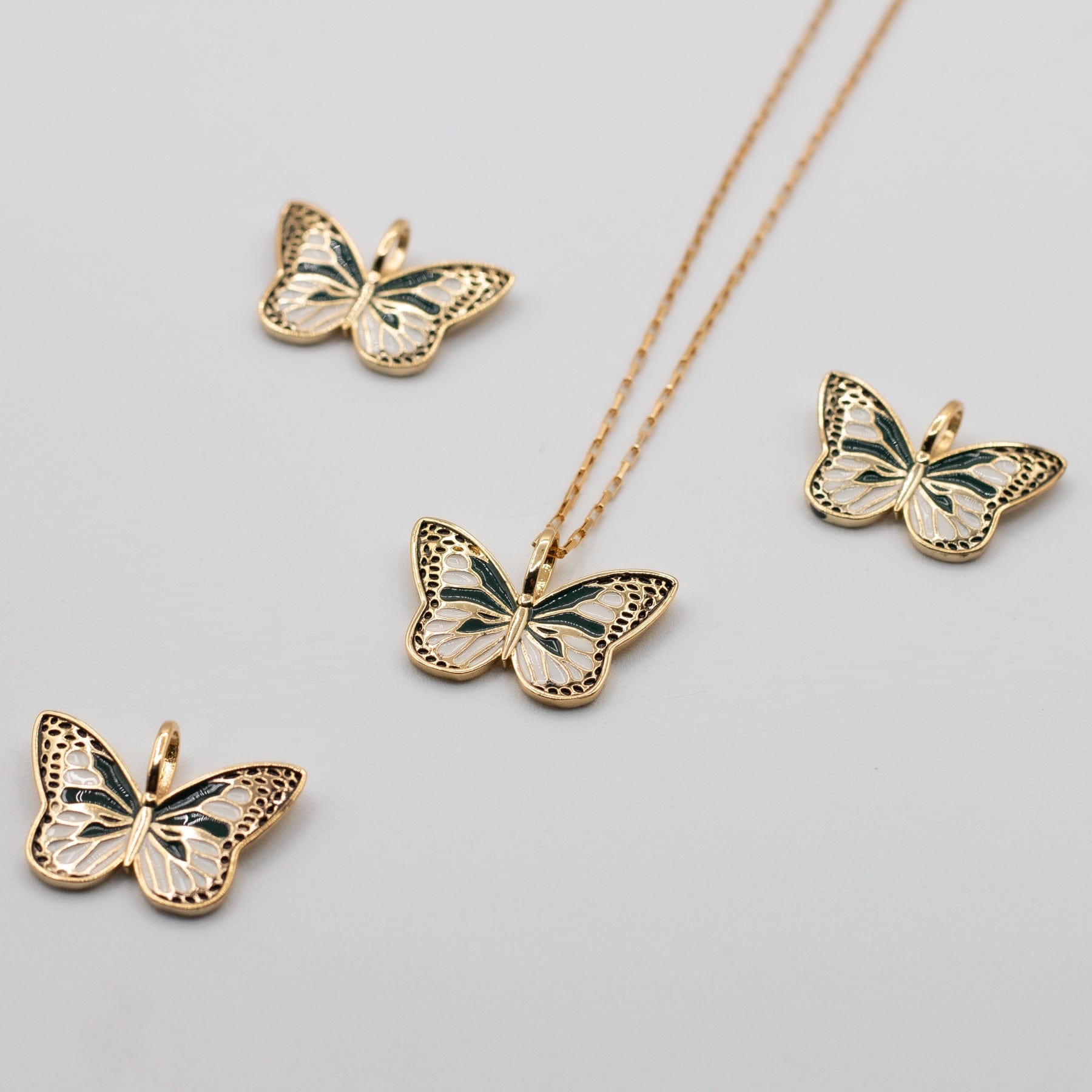 Flutter Necklace with extra charms shown - Dainty enamel and gold filled green white and gold butterfly charm on mini elongated Venetian chain 