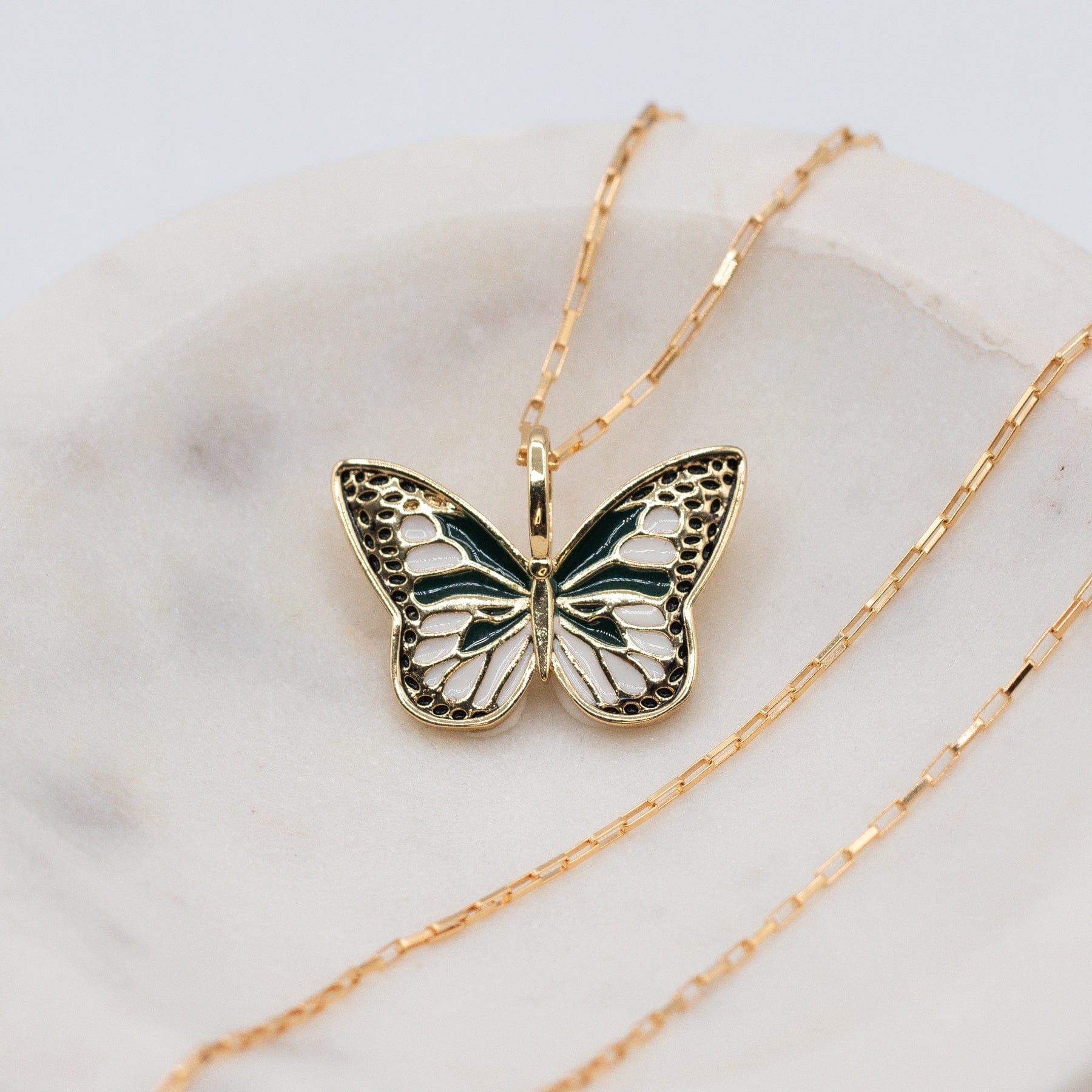 Flutter Butterfly Necklace - Dainty enamel and gold filled green white and gold butterfly charm on mini elongated Venetian chain in marble bowl