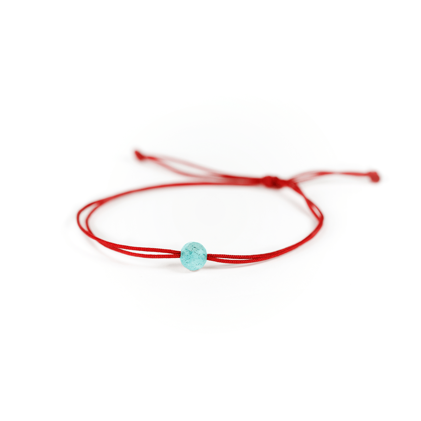 Close up of the turquoise stone with red nylon string.