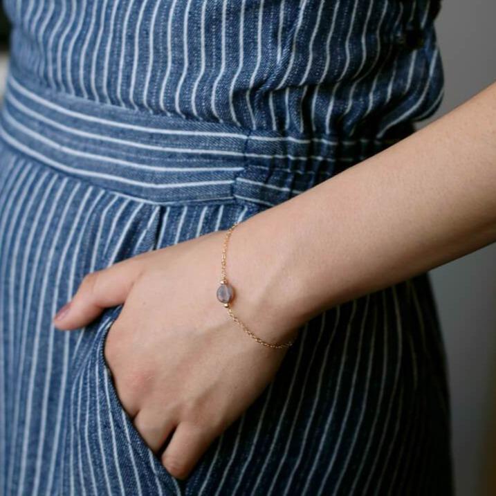 Model wearing botswana agate varied color on gold bracelet