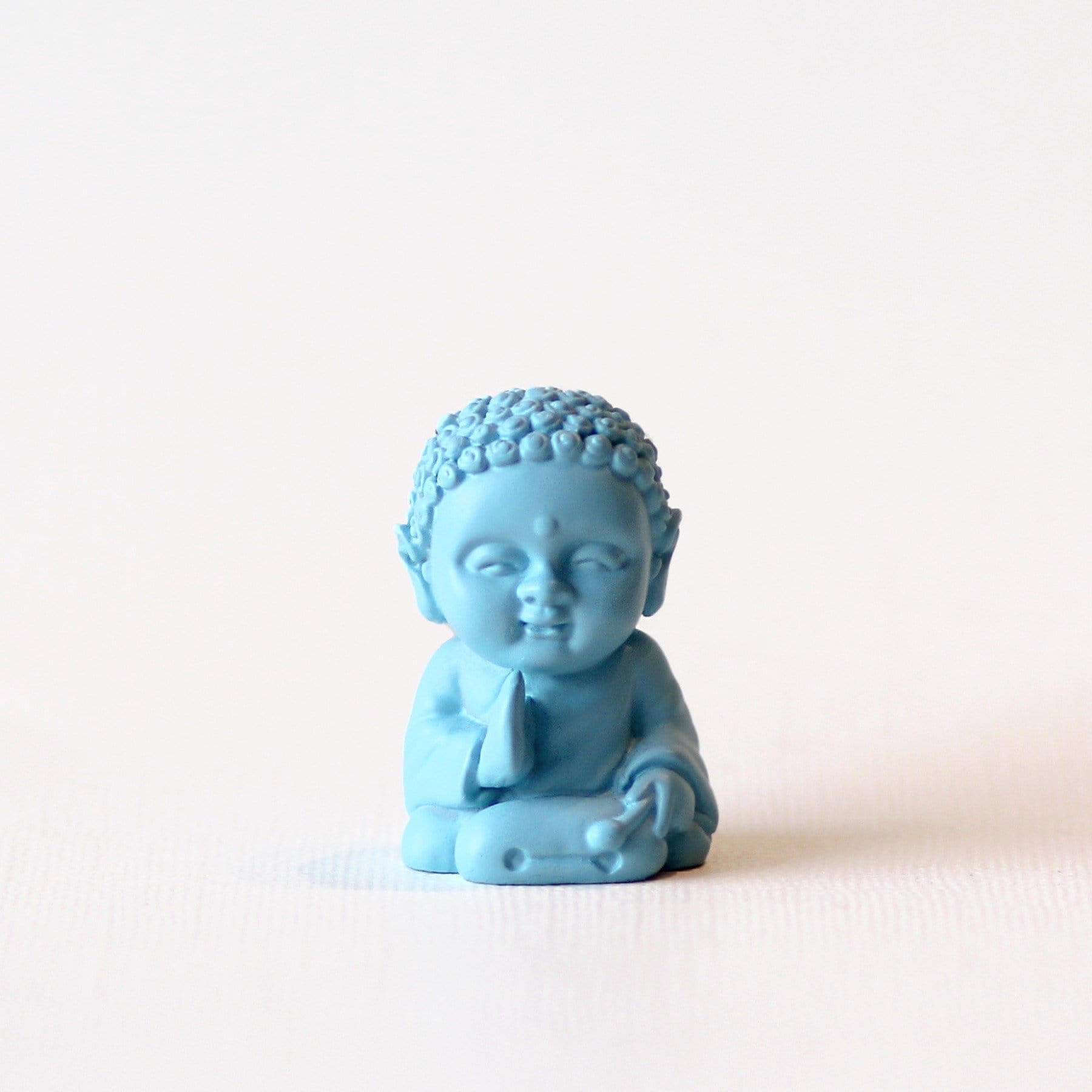 Light blue trust baby buddha statue