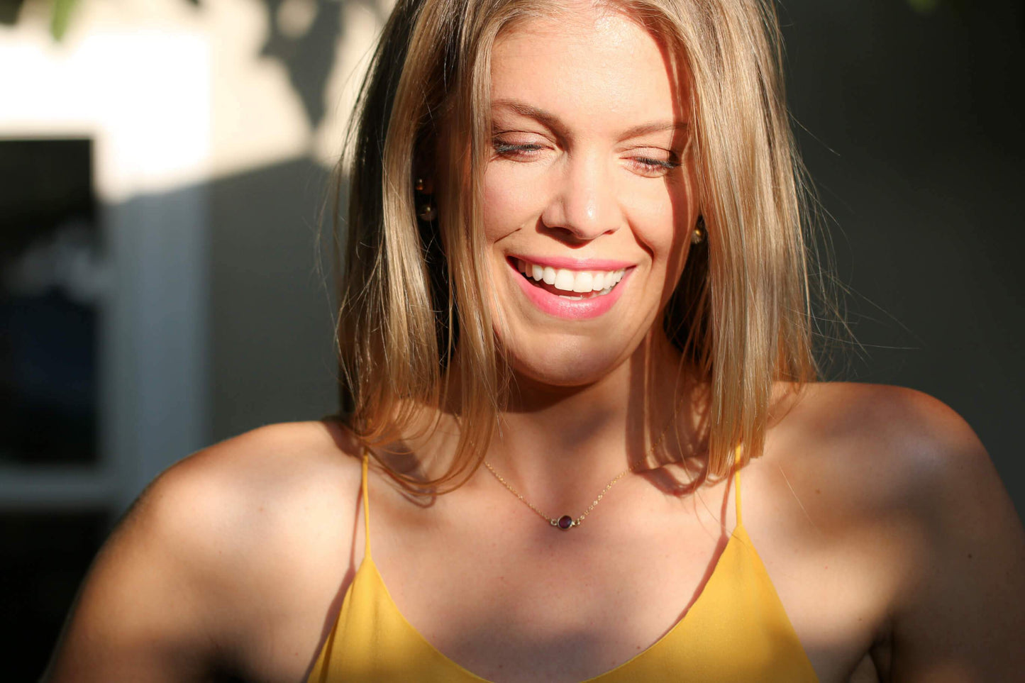 Blonde haired model in yellow cami wearing a genuine amethyst stone gold necklace - MaeMae Jewelry