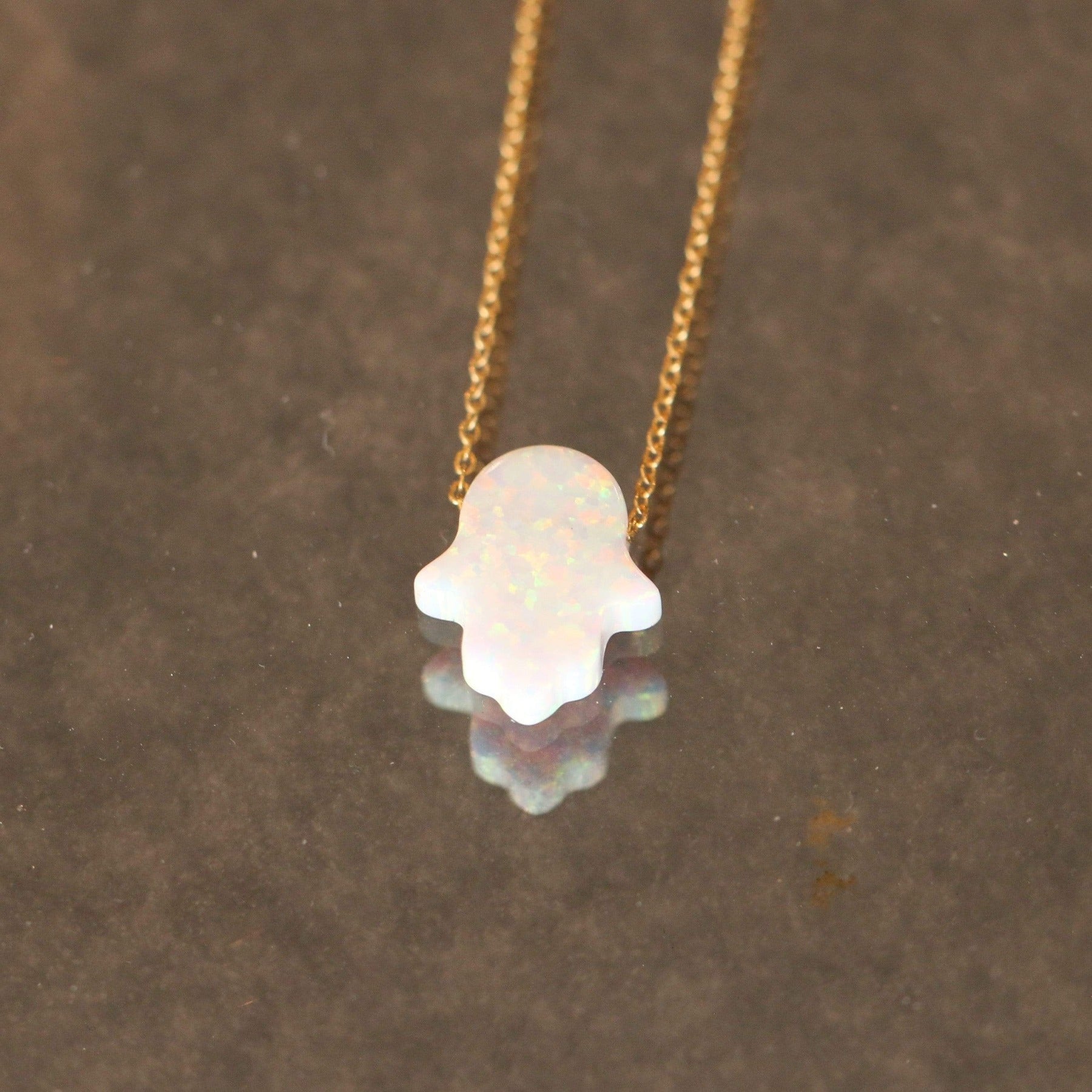 Hamsa Opal Necklace close on glass