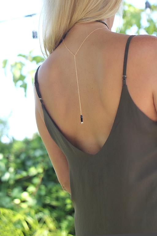 Model wearing lariat necklace with 5 crystal drop hanging over low back dress - MaeMae Jewelry