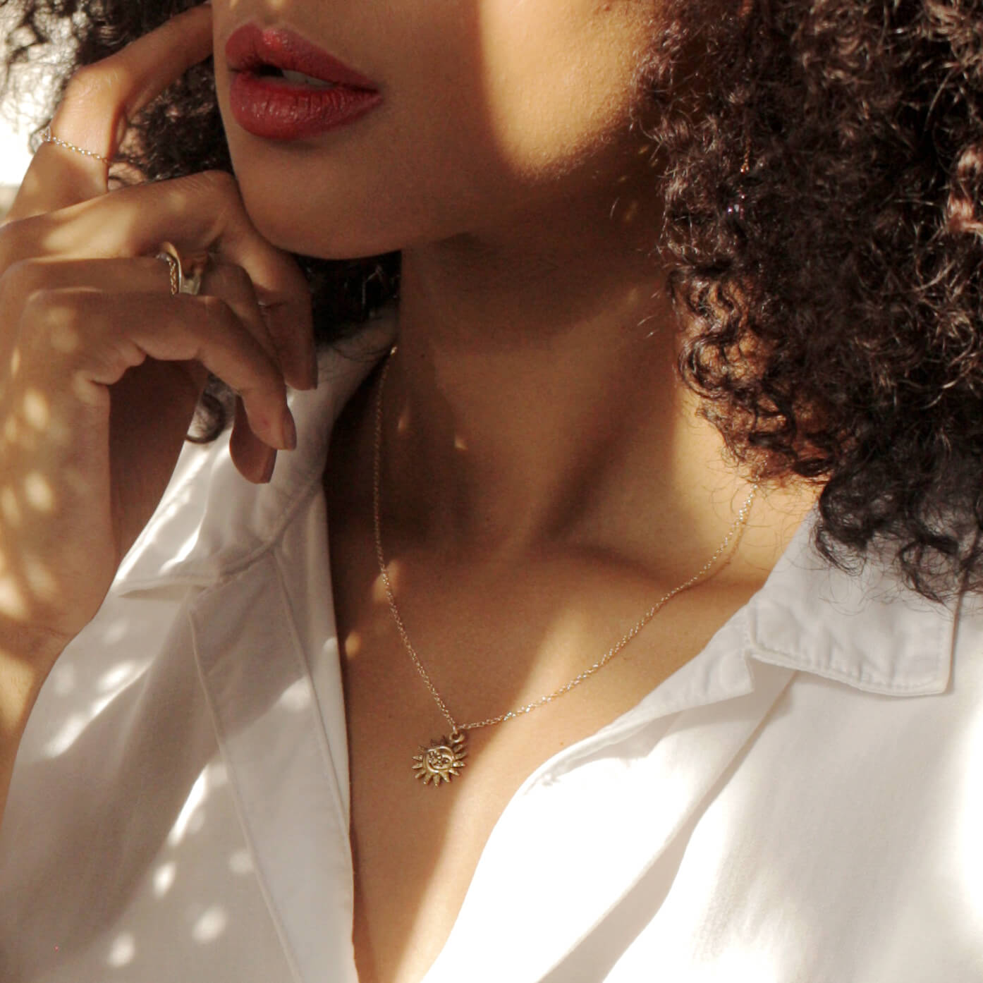 Model wearing a MaeMae 14K Gold Filled Light After Dark Neklace with a gold Sun Moon Charm. L