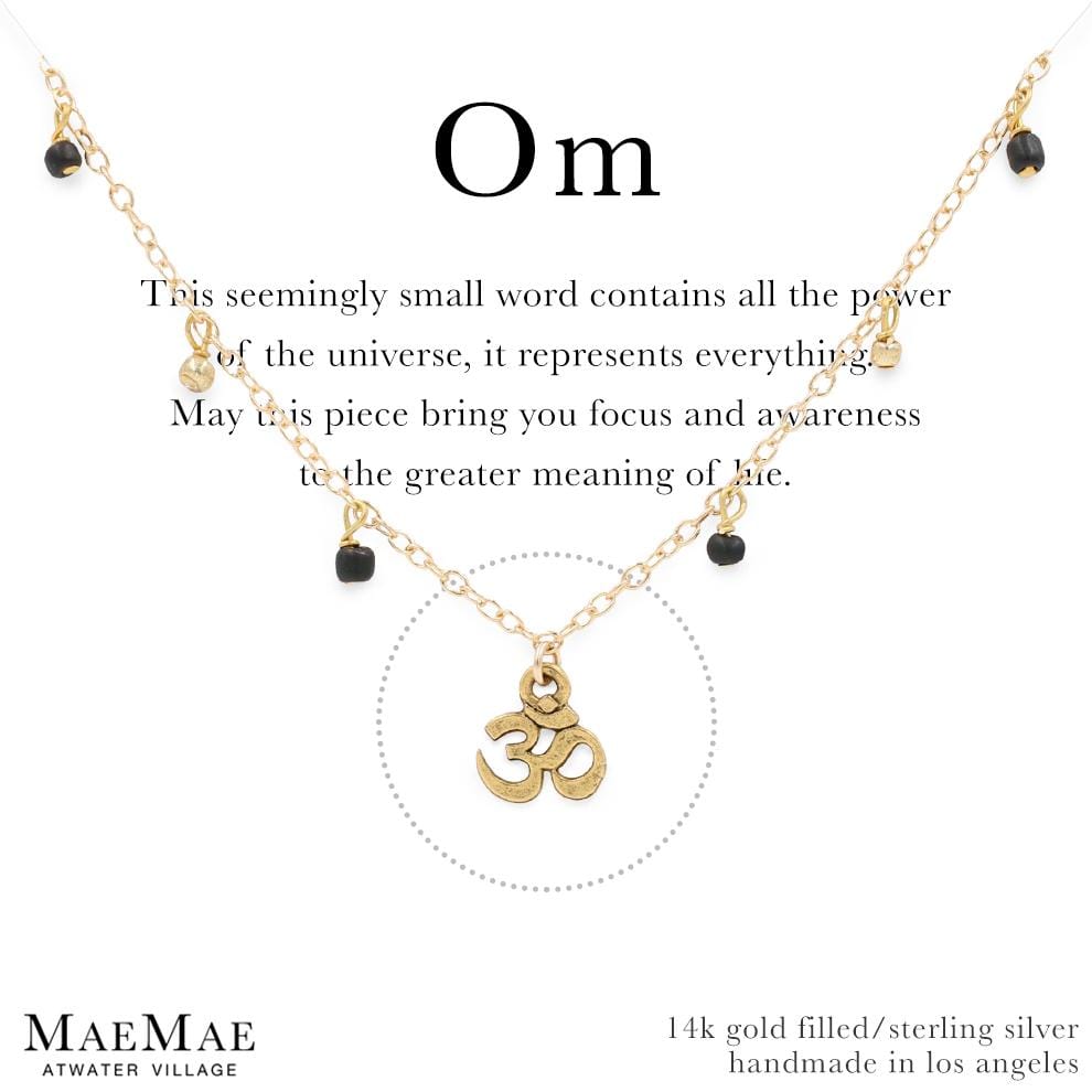 Gold bracelet with small dangling gold balls and small black beads with a dainty om symbol charm on a positive affirmation card - MaeMae Jewelry